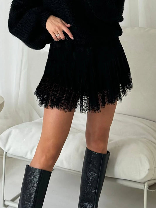 Women's high waist lace pleated mini skirt with a dot pattern and A-line silhouette.

