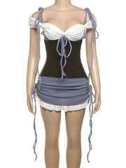 Mannequin wearing a black and white dress with blue accents on a white background