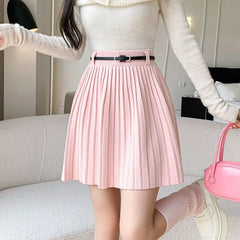 Women's pleated skirt with a belt and high waisted fit.