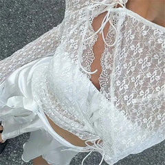 White lace dress with a close-up of the neckline on a dark background