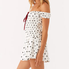 Women's off-shoulder mini dress with polka dots and ruching.