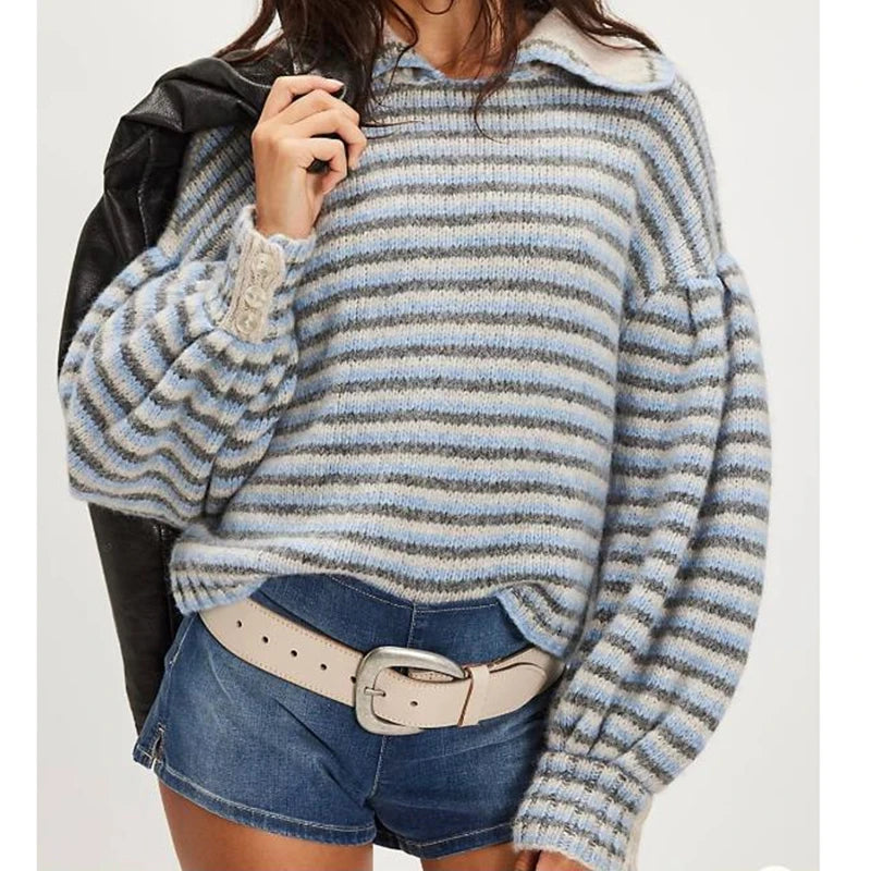 Person wearing a striped sweater and denim shorts on a white background