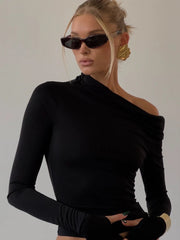 A woman wearing a black off-shoulder top and maxi skirt set, showcasing the flattering silhouette and elegant style, perfect for a special occasion.