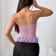 Woman wearing a purple lace top with black pants against a white background