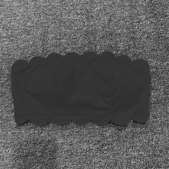 Black rectangular object on a textured gray background