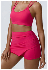 Person wearing a bright pink sports bra and shorts set- side
