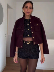  Women's burgundy short jacket with gold button details.