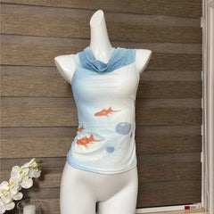 Mannequin wearing a sleeveless top with fish design against a wooden panel background