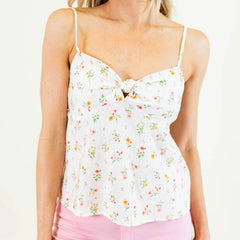 Woman wearing a white floral camisole 
