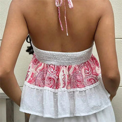 Back view of a person wearing a pink and white patterned top with a ruffled skirt.