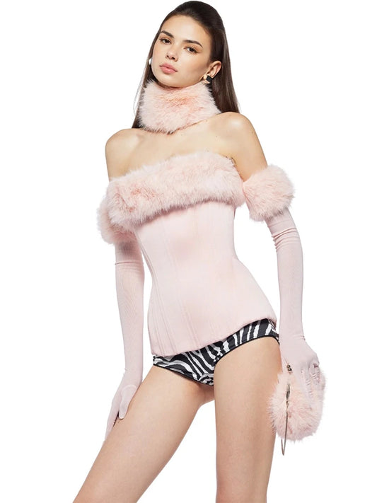 Model wearing a pink outfit with fluffy details on a white background
