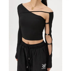 Black off-shoulder top with cut-out sleeves worn by a person 