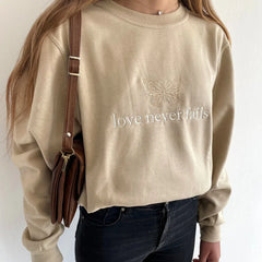 Women's embroidered sweatshirt with a butterfly and inspirational message.