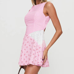 Pink checkered dress with floral skirt on a plain background