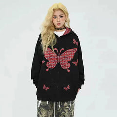 Person wearing a black hoodie with red butterfly designs 