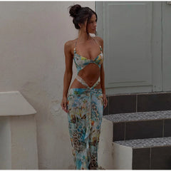 A blue printed maxi dress with cut-out tie-up details, V-neck, and spaghetti straps, perfect for chic summer outings.