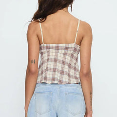 Person wearing a plaid top and light blue jeans - back