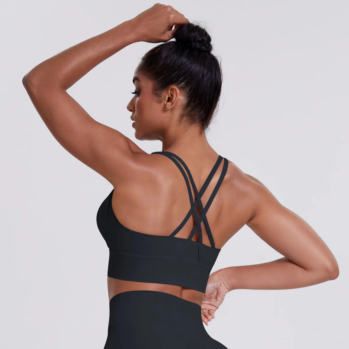 Woman wearing a black sports bra and leggings 