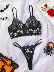 Women's lingerie set with skull embroidery and sheer mesh.