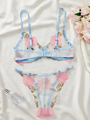 Women's lingerie set with delicate rose embroidery and sheer details.