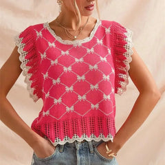 Woman wearing a pink crochet top with white trim on a beige background