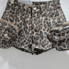 Leopard print denim shorts with zippers on a white background