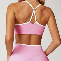 Person wearing a pink sports bra and leggings set -back view