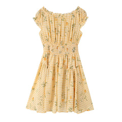 A yellow and white gingham dress with a lemon and green leaf floral print, featuring ruffled cap sleeves, a smocked waist, and a flared skirt, shown against a plain white background.
