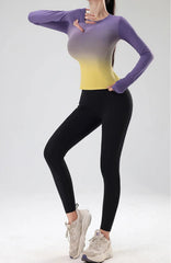 Person wearing a gradient purple to yellow top and black leggings