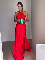 A satin maxi dress featuring braided straps and a twisted design, shown on model.