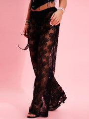 A woman wearing sparkling rhinestone mesh pants with a crop top and heels, perfect for a night out.