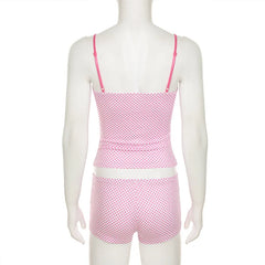 Mannequin wearing a pink polka dot swimsuit 