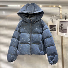 Blue puffer jacket with star patterns on a neutral background