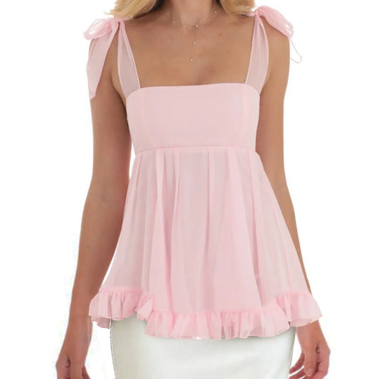 Pink sleeveless top with bow straps worn by a model