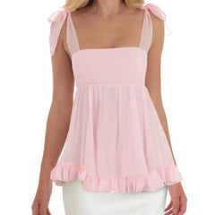 Pink sleeveless top with bow straps worn by a model