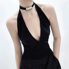 Black dress with a deep neckline on a mannequin against a white background