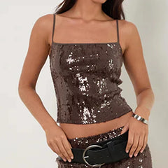 Woman wearing a sequined top and skirt - front view