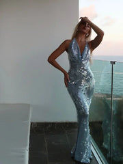 A woman wearing a sparkling blue sequin dress with a flowing silhouette, perfect for a special occasion.