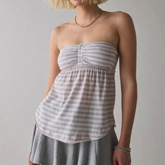 Woman wearing a strapless, light-colored striped dress