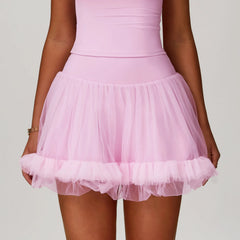 Pink tulle skirt worn by a person on a plain background
