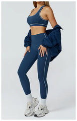 Person wearing a blue athletic outfit with a jacket - side view