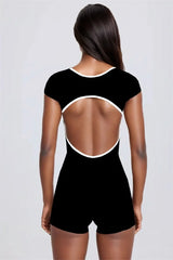 Black open-back romper worn by a model - back view