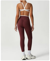 Person wearing maroon leggings and a white sports bra - back view