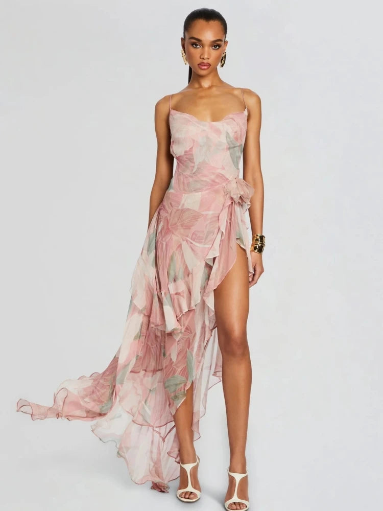 Woman wearing a floral one-shoulder dress on a plain background