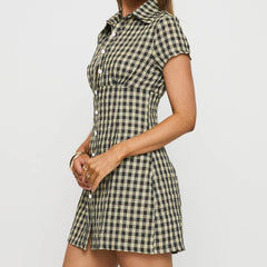 Person wearing a checkered dress on a plain background