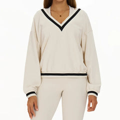 White outfit with black trim worn by a person - front view