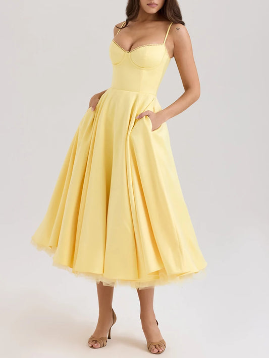 Yellow dress worn by a model on a plain background