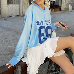 A woman wearing a blue jersey top with skirt, showcasing its versatility and casual style.