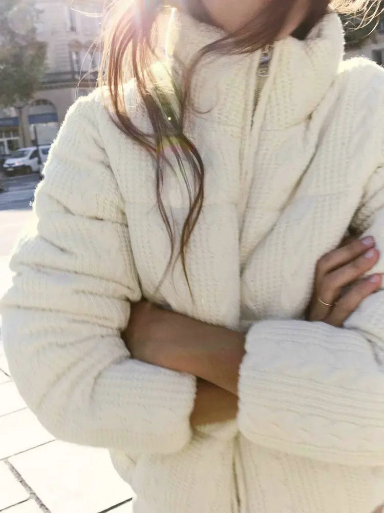 Person wearing a cream-colored knit sweater 