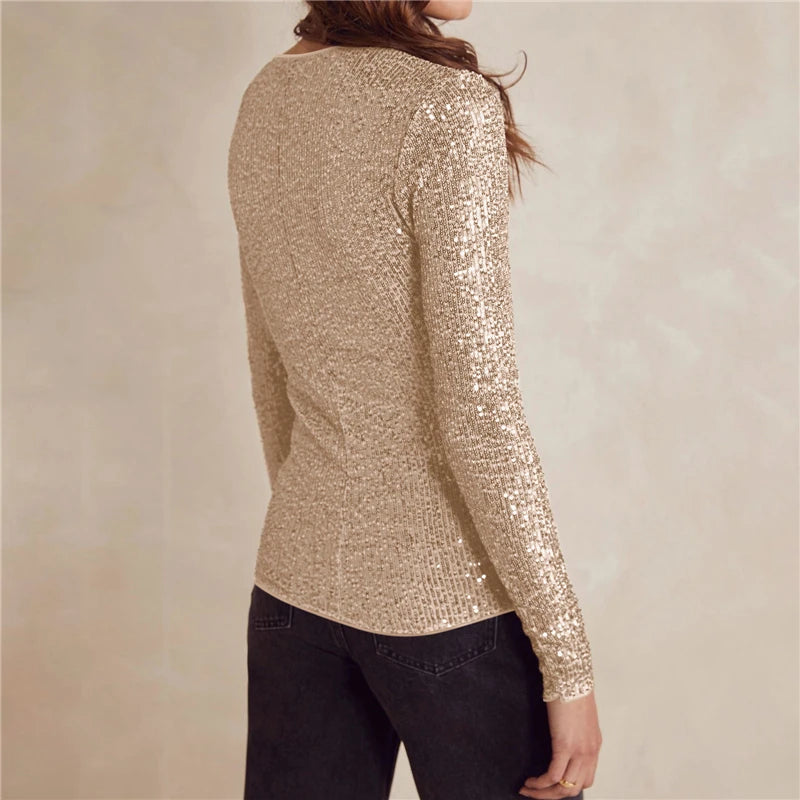 Gold sequin long-sleeve top worn by a person